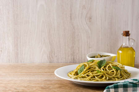 Spaghetti pasta with pesto sauce on wooden table. Copyspaceの写真素材