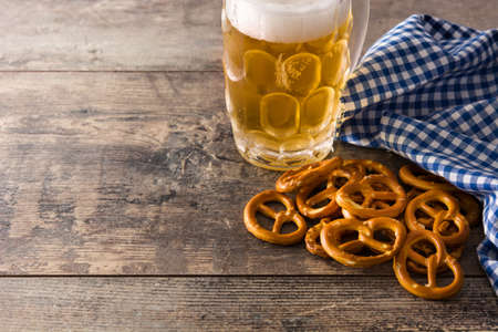 Beer with pretzels to celebrate Oktoberfest on wooden table. Copyspaceの写真素材
