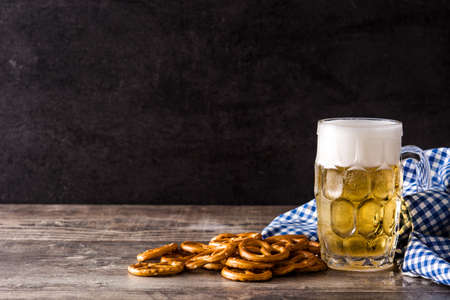 Oktoberfest beer with pretzels on wooden table. Copyspaceの写真素材