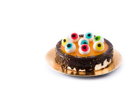 Halloween cake with candy eyes decoration isolated on white background. Copyspaceの写真素材