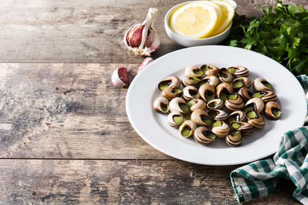 Escargots de Bourgogne on wooden table. Copyspaceの写真素材