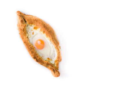 Traditional Adjarian Georgian khachapuri with cheese and egg isolated on white background. Top view....