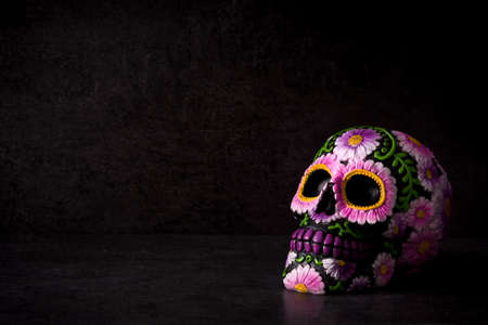 Typical Mexican skull painted on black background.Copyspace. Dia de los muertos.
