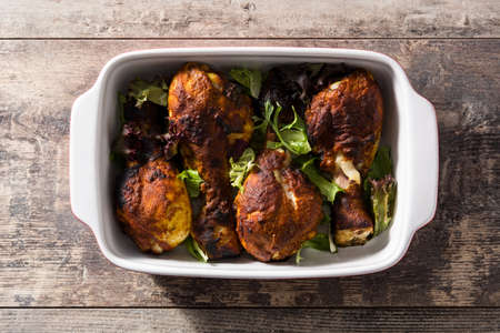 Roasted tandoori chicken with basmati rice on wooden table. Top viewの写真素材