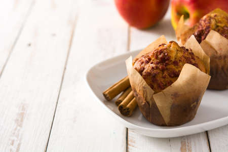 Apples and cinnamon muffins on wooden table. Copyspaceの写真素材