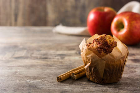 Apples and cinnamon muffins on wooden table. Copyspaceの写真素材