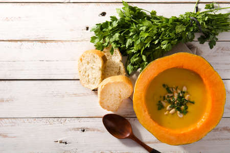 Pumpkin and carrot soup on white wooden table. Autumn food Top view. Copy spaceの写真素材