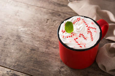 Peppermint coffee mocha for Christmas on wooden table. Copy spaceの写真素材