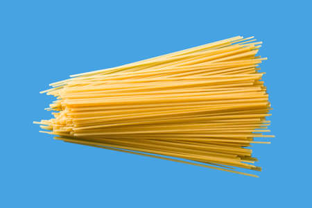 Raw Spaghetti Pasta Isolated on Blue Background