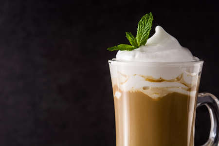 Peppermint coffee mocha for christmas on wooden table and black background.の写真素材