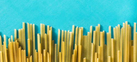 Raw Spaghetti Pasta on blue background. Panorama viewの写真素材