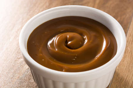 Traditional Latin American dulce de leche or delicacy on wooden background.の写真素材