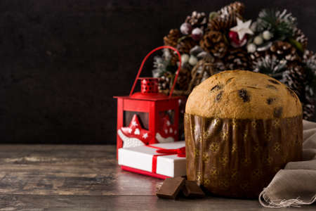 Christmas chocolate panettone cake on wooden table. Copy spaceの写真素材