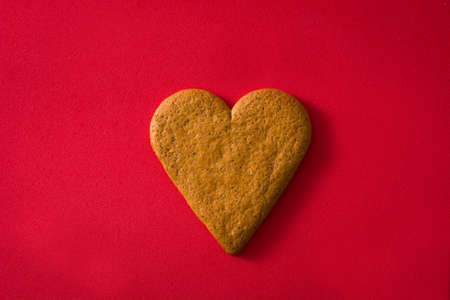 Heart shaped cookie isolated on red background. Valentine's Day and Mother's Day concept.の写真素材