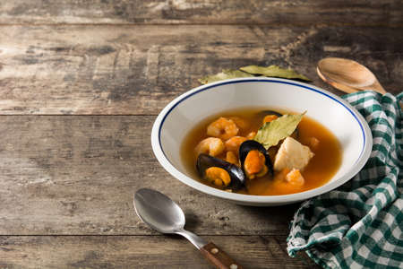 French bouillabaisse soup on wooden table. Copy spaceの写真素材
