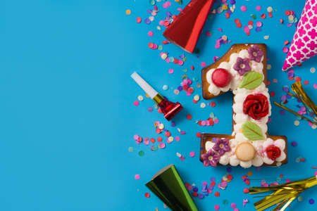 Number one cake decorated with flowers, macarons on blue backgroundの写真素材