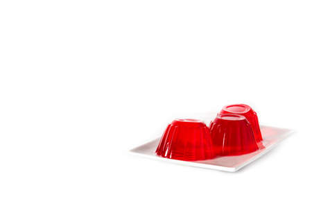 Strawberry jellies on a plate isolated on white background. Copy space