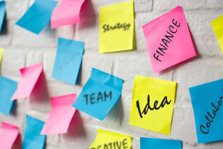 Business plan made with colored notes on white wallの写真素材