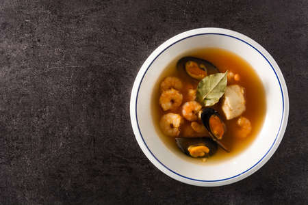 French bouillabaisse soup in white plate on black background. Top view Copy spaceの写真素材