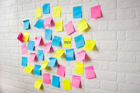 Business plan made with colored notes on white wallの写真素材