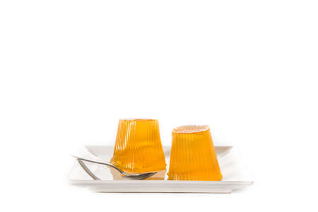 Orange jellies on a plate isolated on white background