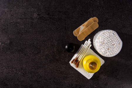 Medical iodine in a bottle and gauzes on black background.Top view. Copy space