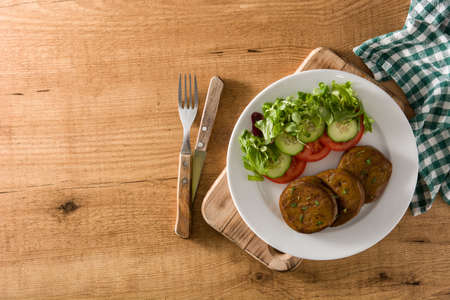Seitan with vegetables on wooden table. Fake meatの写真素材