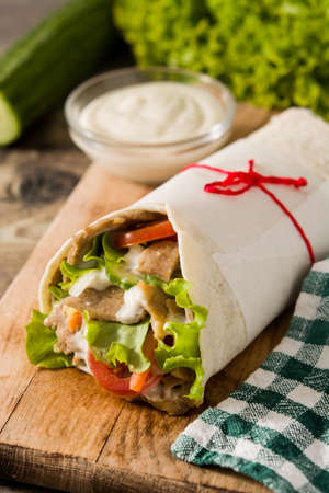 Doner kebab or shawarma sandwich on wooden table.の写真素材