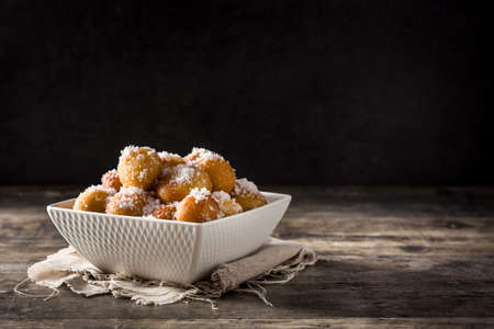 Carnival fritters or buÃ±uelos de viento for holy week on wooden tableの写真素材