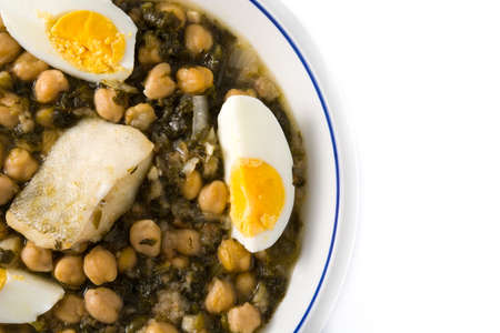 Chickpea stew with spinach and cod or potaje de vigilia isolated on white backgroundの写真素材