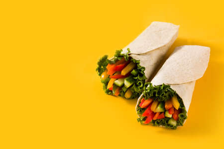 Vegetable tortilla wraps on yellow backgroundの写真素材