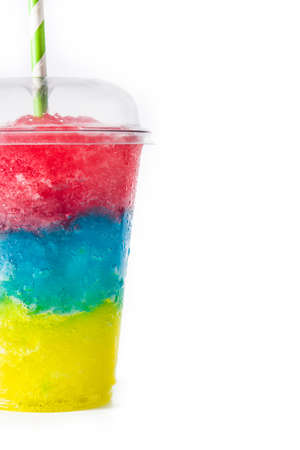 Colorful slushie of differents flavors with straw in plastic cup isolated on white background