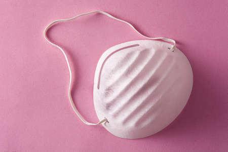 Medical face mask on pink backgroundの写真素材