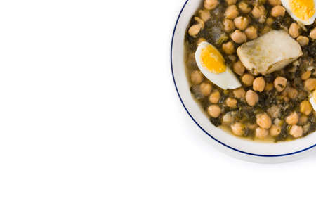 Chickpea stew with spinach and cod or potaje de vigilia on wooden tableの写真素材