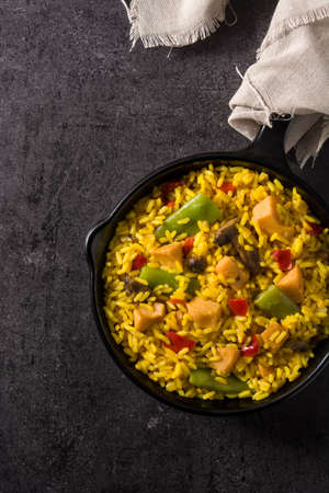 Fried rice with chicken and vegetables on frying iron panの写真素材