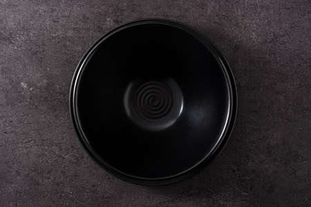 Black bowl on black slate backgroundの写真素材