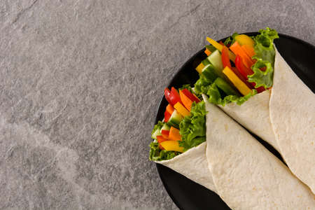 Vegetable tortilla wraps and ingredients on gray stone backgroundの写真素材