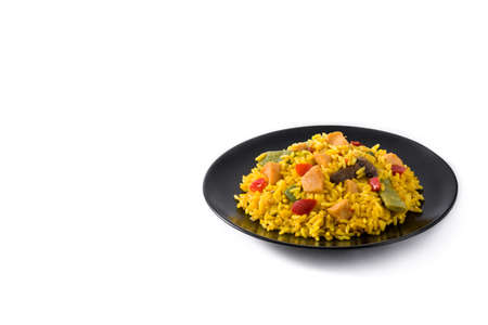 Fried rice with chicken and vegetables on black plate isolated on white backgroundの写真素材