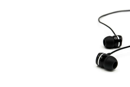 Black earphones isolated on white backgroundの写真素材