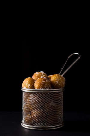 Carnival fritters or buñuelos de viento for holy week on black backgroundの写真素材
