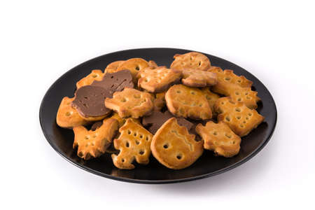Halloween cookies on black plate isolated on white backgroundの写真素材