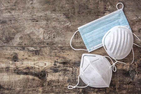 Set of medical protective face masks for coronavirus on wooden tableの写真素材