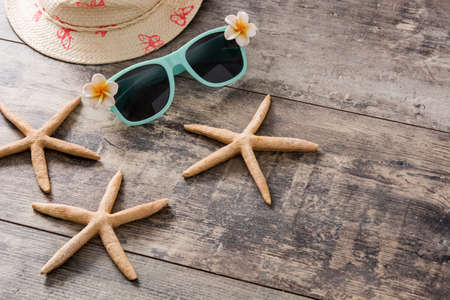 Sunglasses,starfish and summer hat on wooden backgroundの写真素材