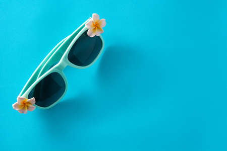 Sunglasses with flowers on blue backgroundの写真素材