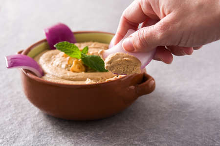 Hand dipping gofio escaldado. Traditional Canarian food.の写真素材