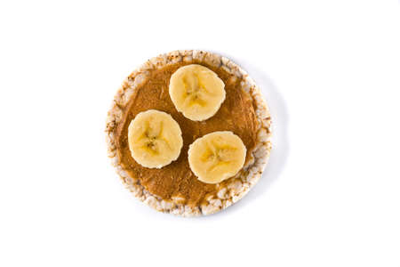 Puffed rice cake with banana and peanut butter isolated on white backgroundの写真素材