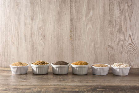Assortment of different seeds in bowl isolated on white background. Pumpkin, linen, chia, sunflower,...
