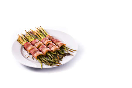 Green asparagus wrapped with bacon isolated on white backgroundの写真素材