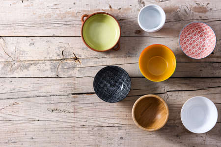 Set of different empty bowls on wooden backgroundの写真素材