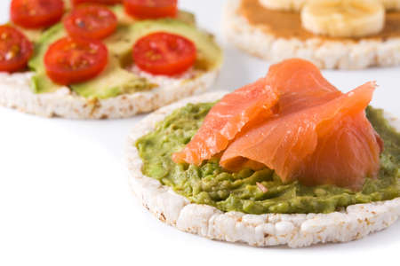 Assortment of ingredients on puffed rice cakes isolated on white backgroundの写真素材